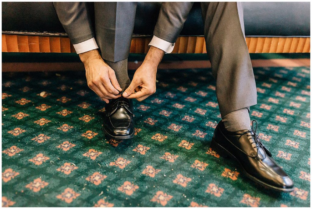 groom tying shoe