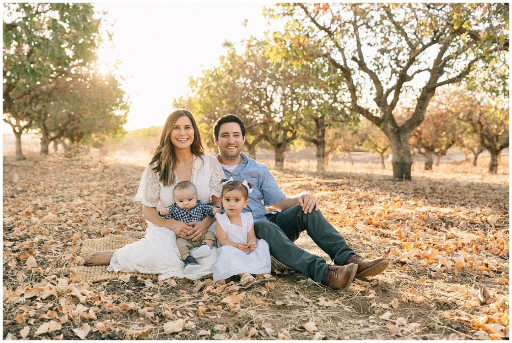 Family sitting in leaves fall session