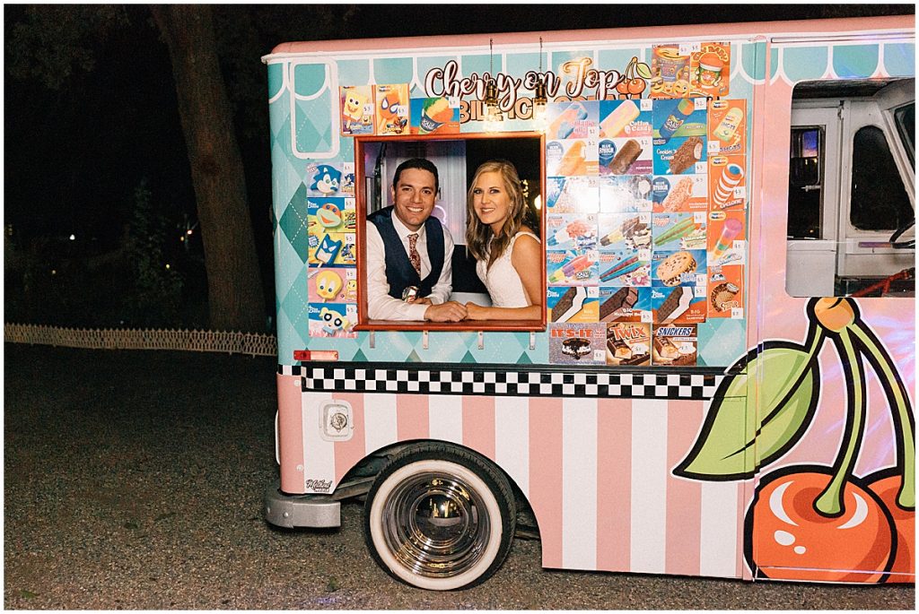 bride and groom sitting in ice cream truck