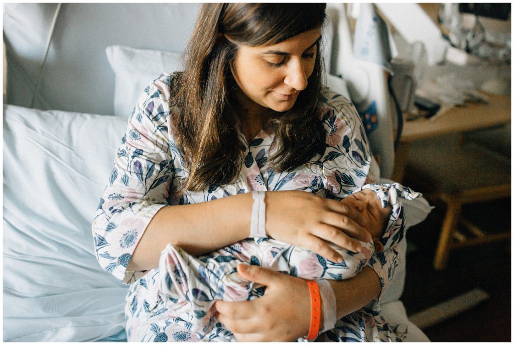 mom holding newborn at hospital