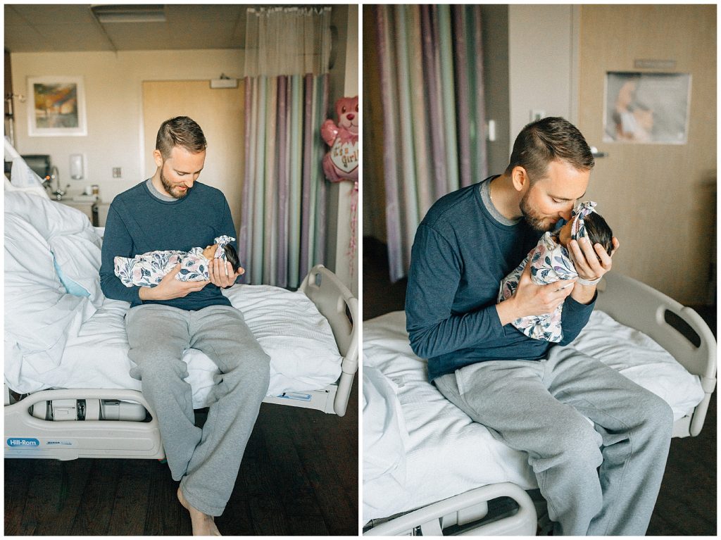 dad holding newborn baby at hospital 