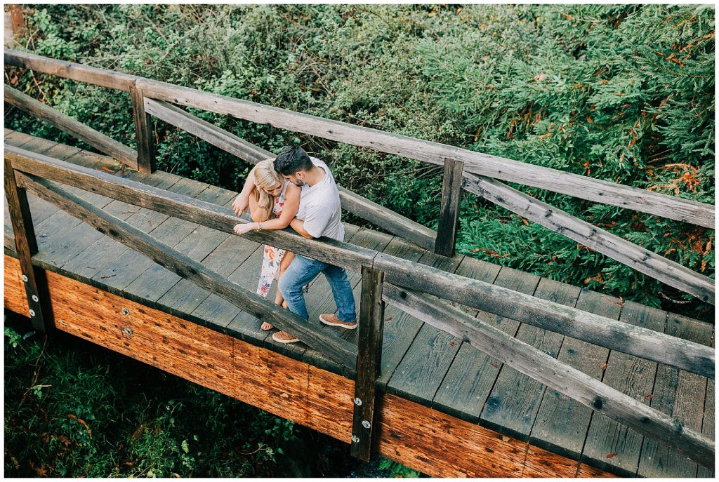 couple standing on bridge 