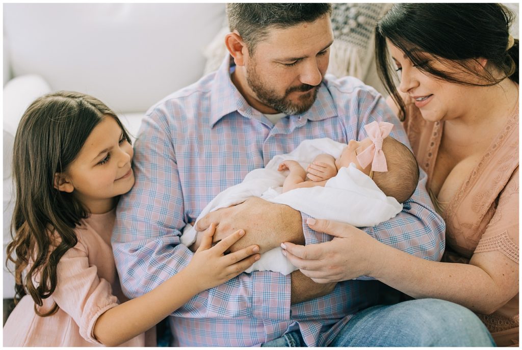 family holding newborn baby girl
