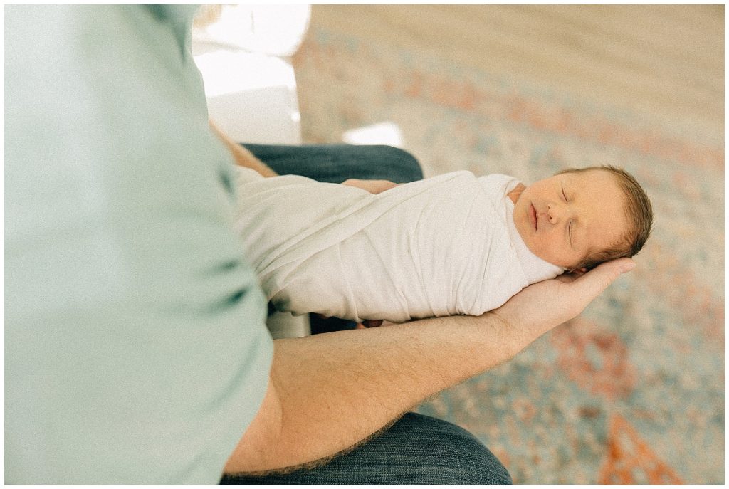 dad holding newborn boy